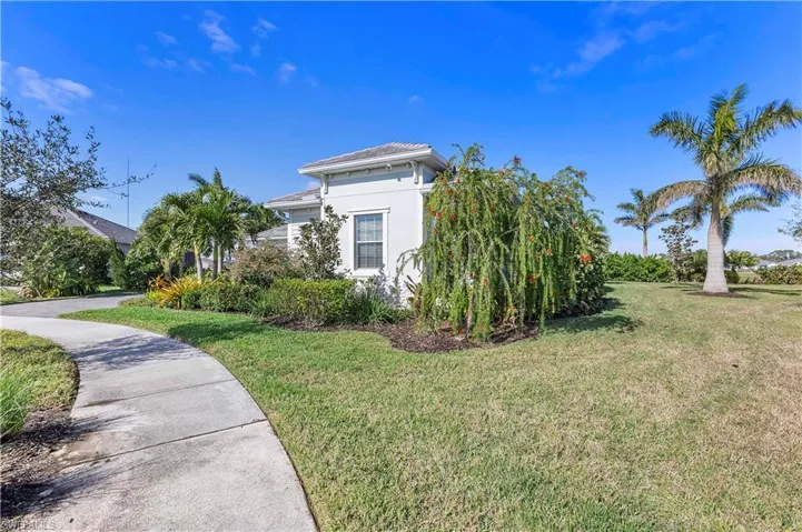 View of property exterior with stucco siding and a lawn