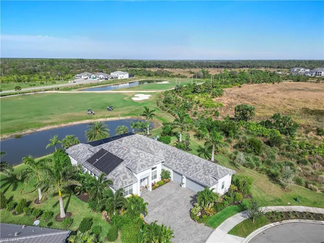Aerial view with view of golf course and a water view