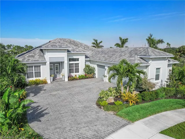 Ranch-style home featuring a garage, decorative driveway, and stucco siding