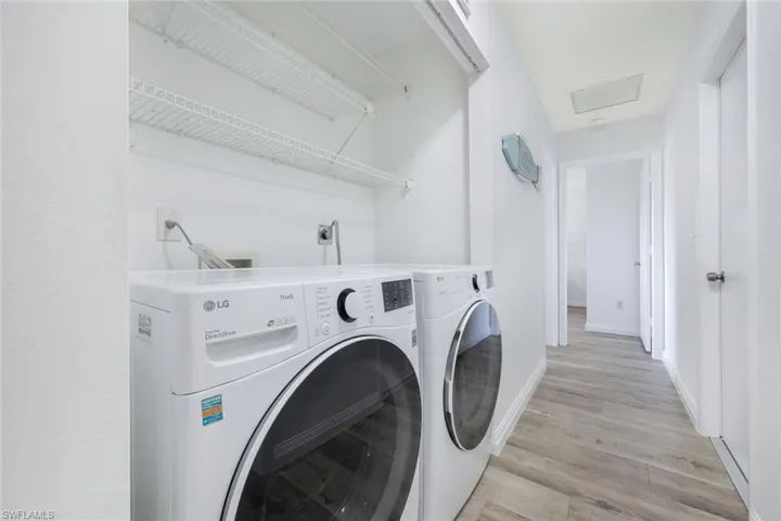 Laundry area featuring washer and dryer and light hardwood / wood-style floors