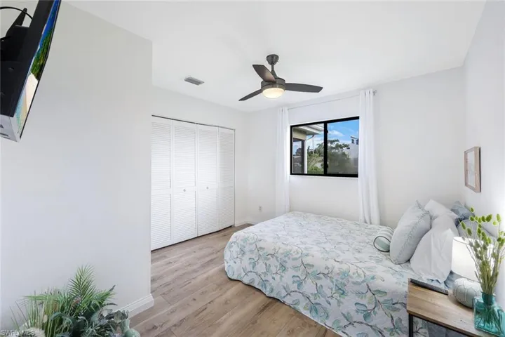 Bedroom featuring light hardwood / wood-style floors, a closet, and ceiling fan