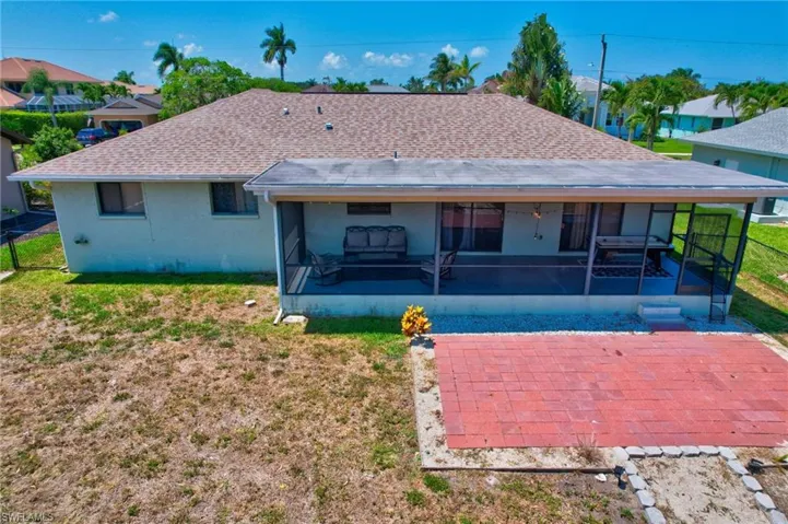 Back of property with a yard
