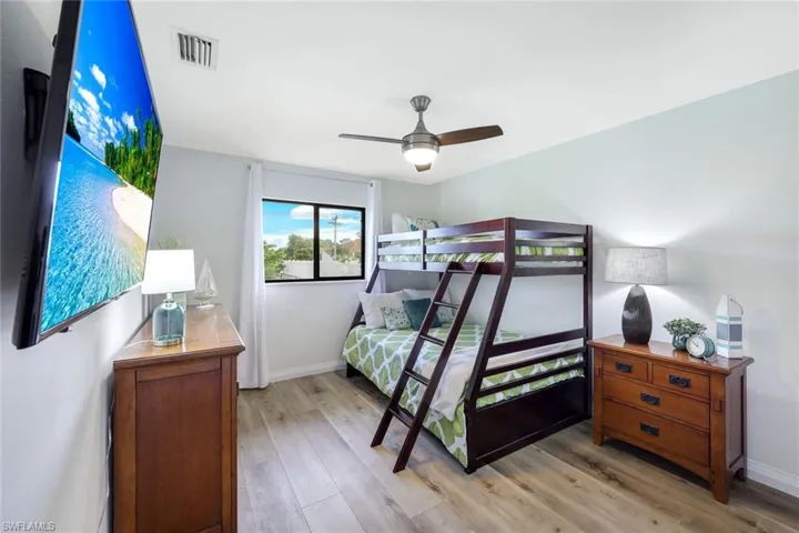 Bedroom featuring ceiling fan and light hardwood / wood-style flooring