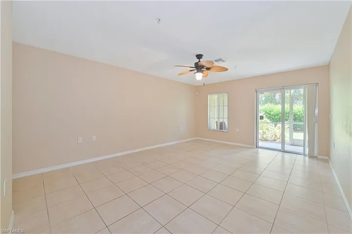 Tiled empty room with ceiling fan