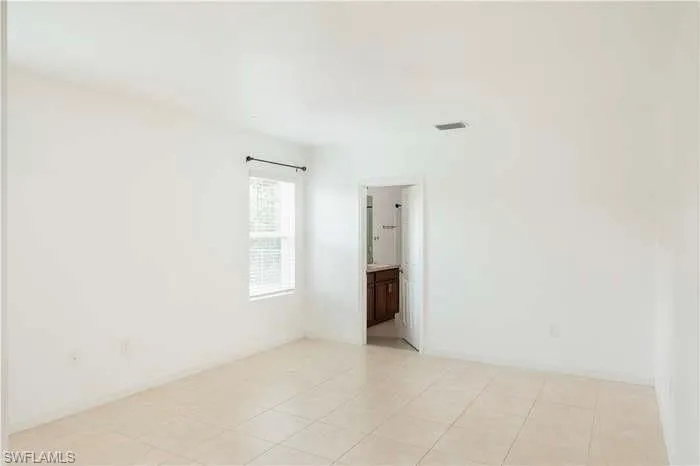 Empty room with light tile patterned floors