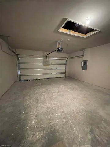 Garage featuring a garage door opener