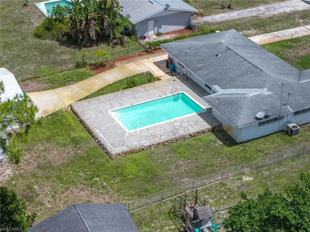 The property features a private swimming pool with a concrete patio surround