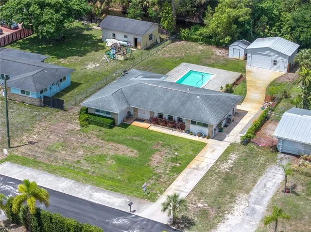 The property features an outdoor swimming pool, a detached garage, and a separate storage shed