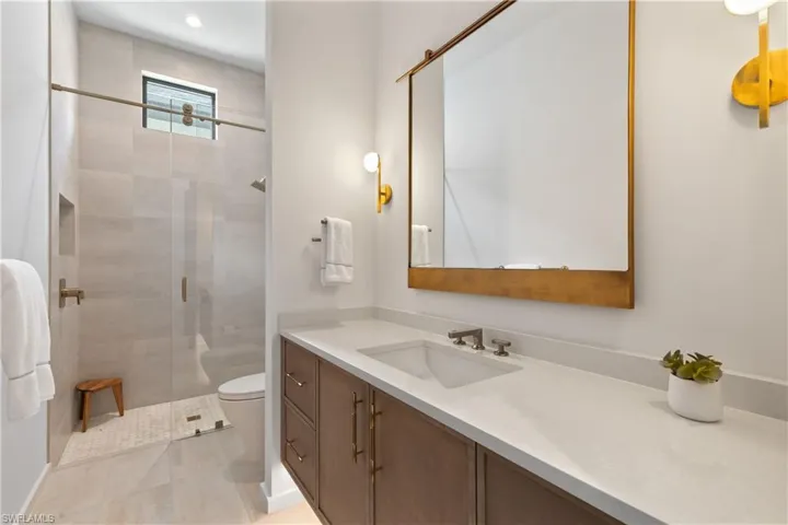 5th full bath offers walk-in shower single vanity.