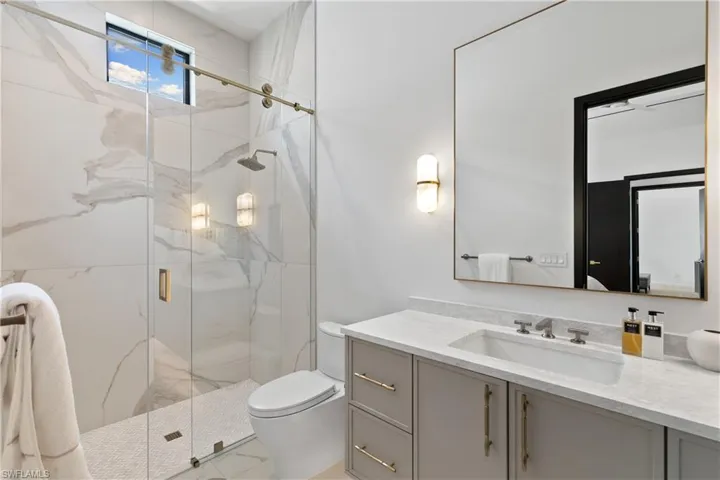 3rd ensuite full bath with walk in shower. with barn door access.