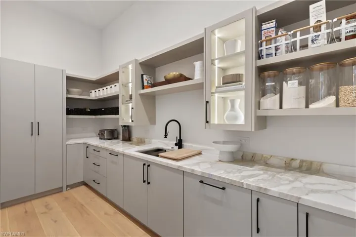 Butler's pantry offers a coffee station, dual “lazy Susan’s”, a 2nd Cove dishwasher, Franke sink system, microwave.
