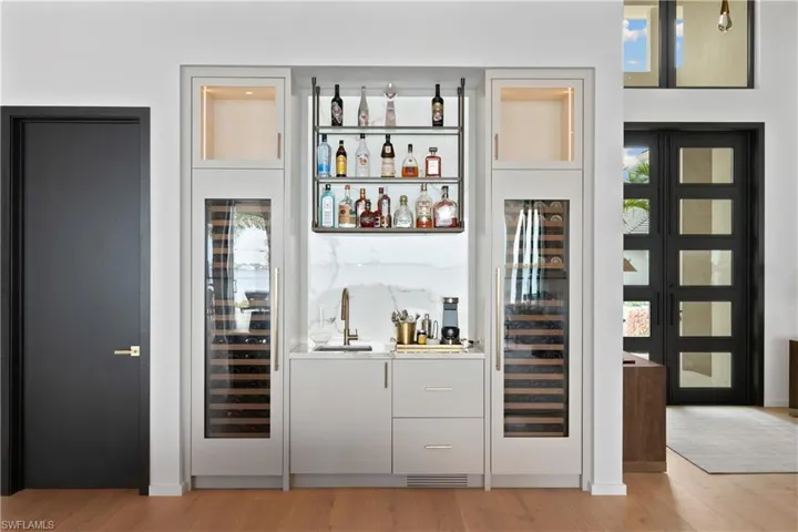 Built-in bar with backlit Onyx and dual Sub-Zero wine storage systems that holds 210 bottles.