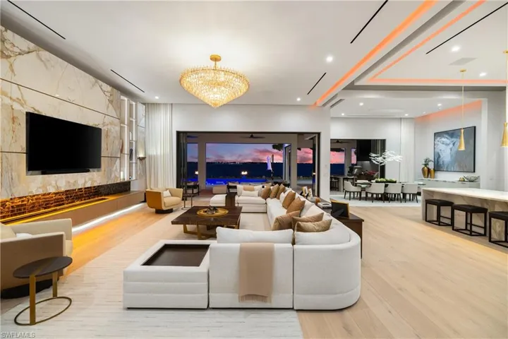 Below the T.V. is a NetZero Platinum Water Vapor Fireplace.