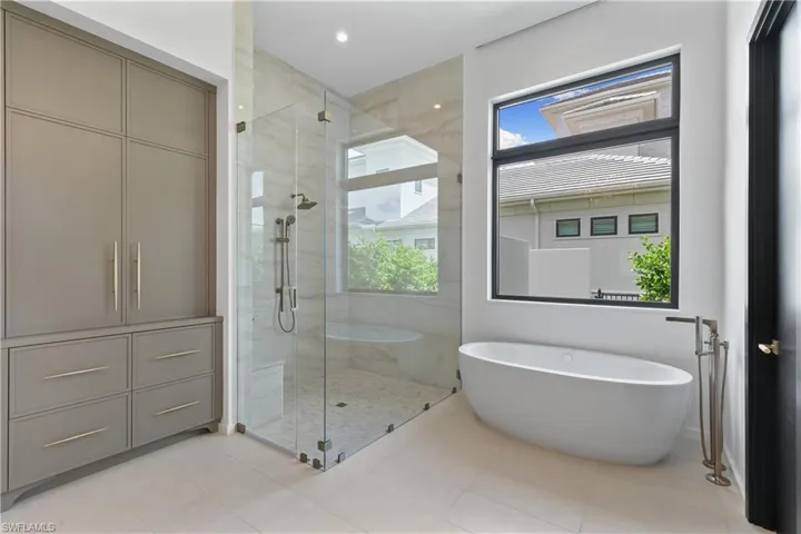 Separate soaking tub and seamless glass enclosed walk in shower. Private water closet. Ample storage.