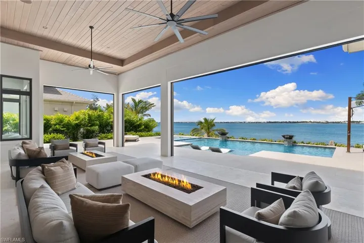 Outdoor space welcomes relaxation! Automated roll down bug screens and automated roll down Kevlar hurricane screens. This home has a mosquito misting system. 2 Restoration Hardware fire tables.