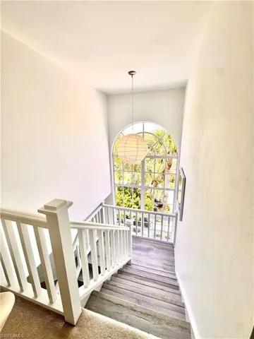 Staircase featuring wood finished floors