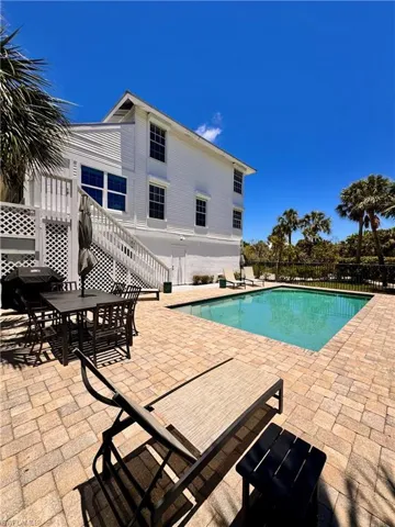 View of swimming pool with a patio, area for grilling, and outdoor dining space