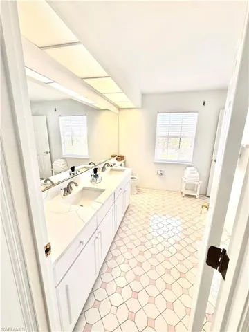 3rd level Bathroom with double vanity and tile patterned floors