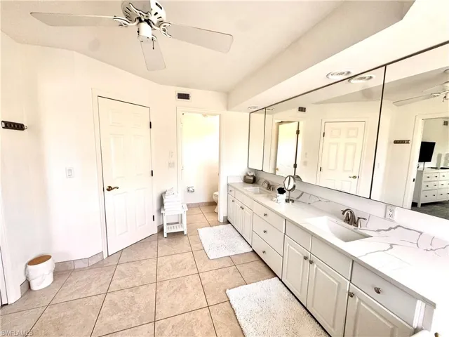 Master - Full bath with double vanity, a ceiling fan, and tile patterned floors, shower and whirlpool bath tub