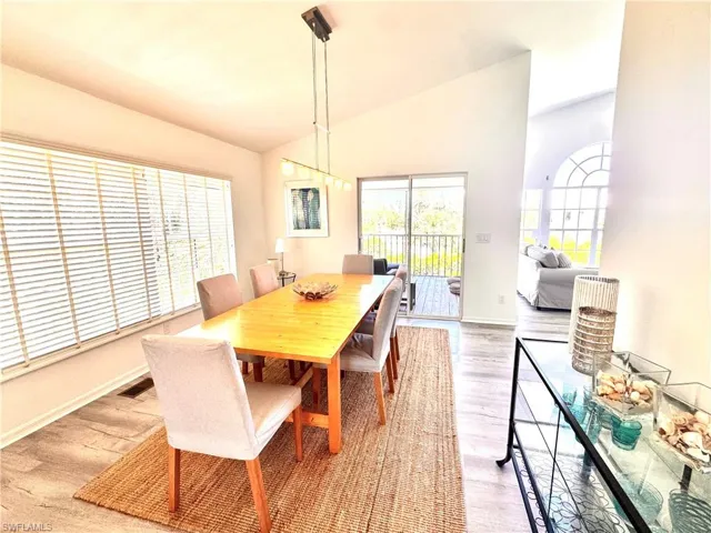 Dining space featuring vaulted ceiling and light wood-type flooring