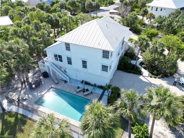 Aerial view of property and surrounding area featuring a pool