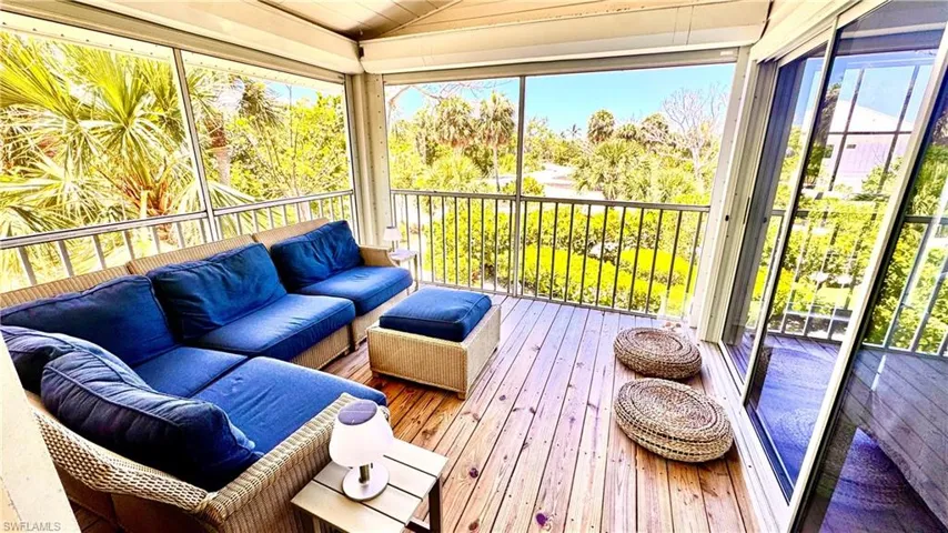 Sunroom featuring an outdoor hangout area, lofted ceiling, and healthy amount of natural light