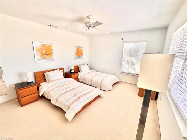 3rd level Carpeted bedroom featuring baseboards and ceiling fan