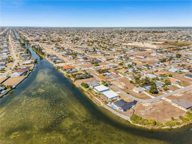 Aerial overview of property's location with nearby suburban area and a large body of water