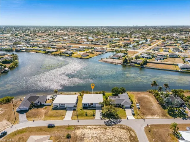 Aerial view of property's location with nearby suburban area