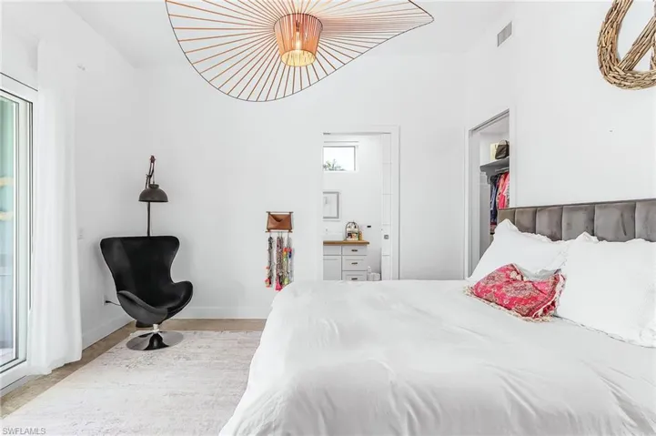 Bedroom with baseboards and access to outside