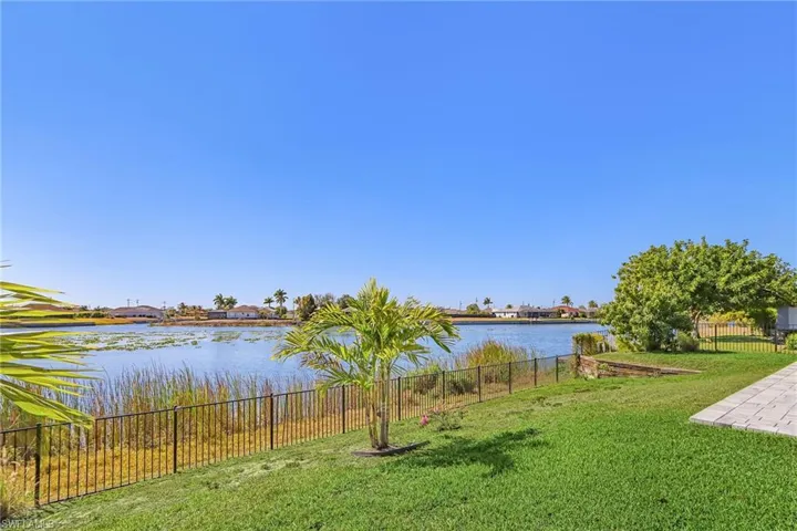 Fenced yard featuring a water view