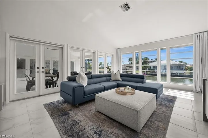 The primary bedroom sitting area overlooks the patio space and the canal