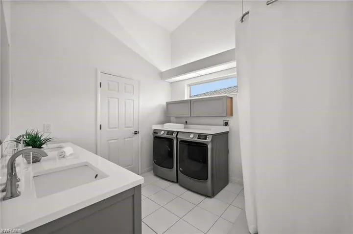 Primary bath and laundry combo. Oversized walk-in closet adjacent