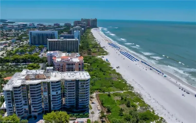 Aerial view featuring a water view and a beach view