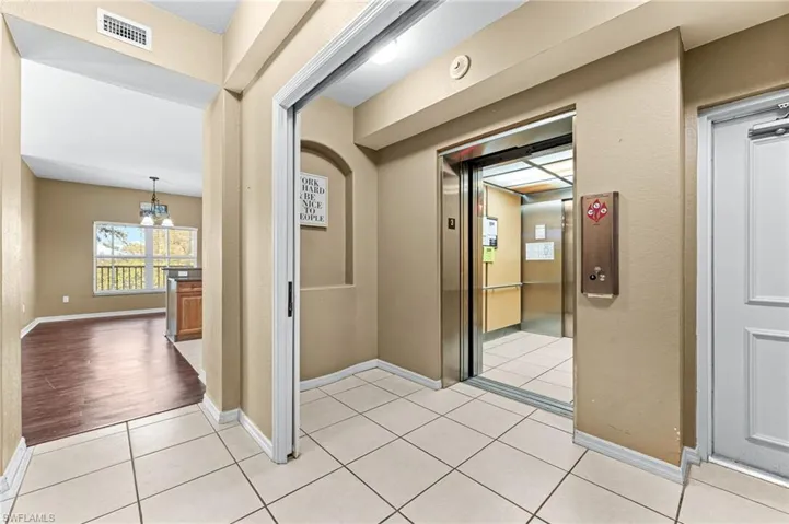 Elevator opens to unit- entry way with pocket door into condo