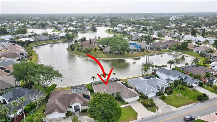 Birds eye view of property with a residential view and a water view