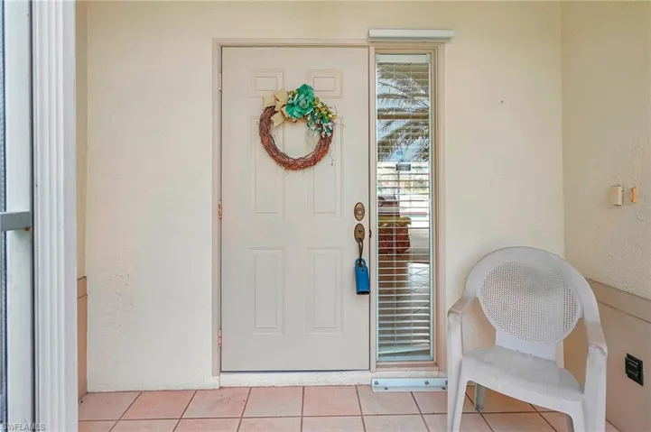 Doorway to property featuring stucco siding