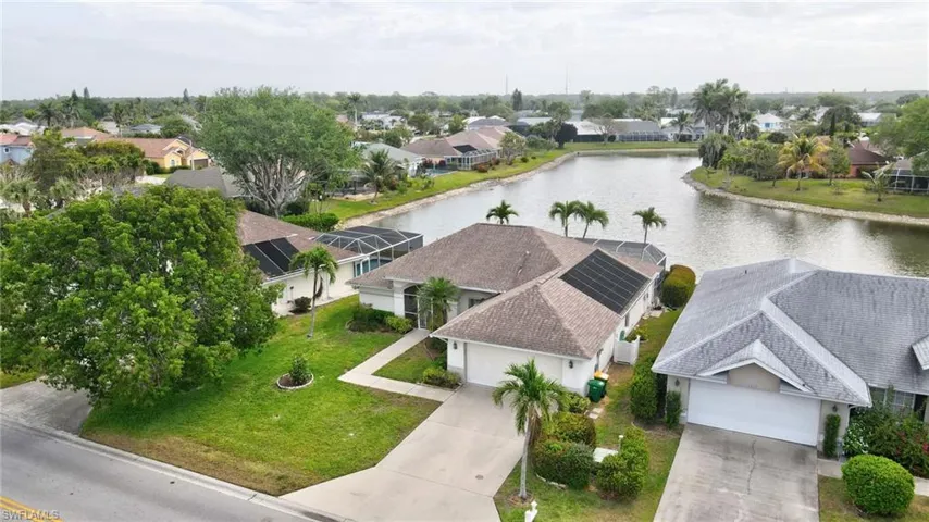 Birds eye view of property with a residential view and a water view