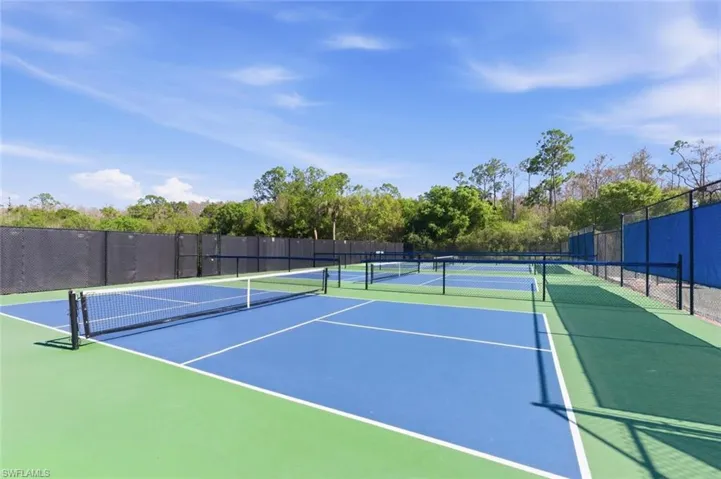 View of tennis/pickleball court with community basketball court