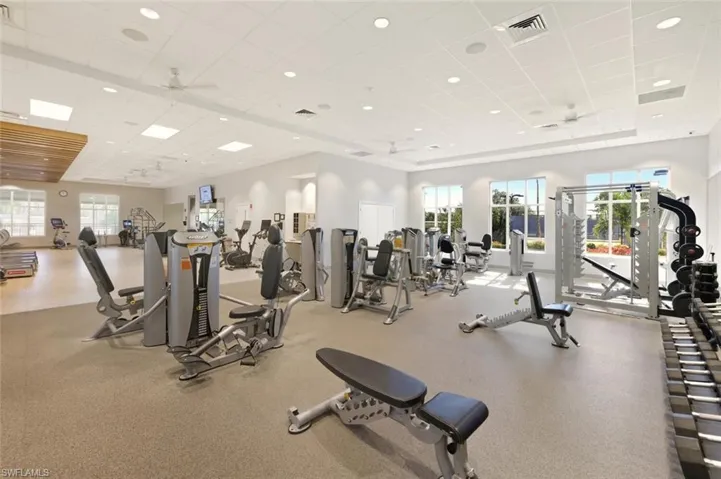 Gym featuring a paneled ceiling and ceiling fan
