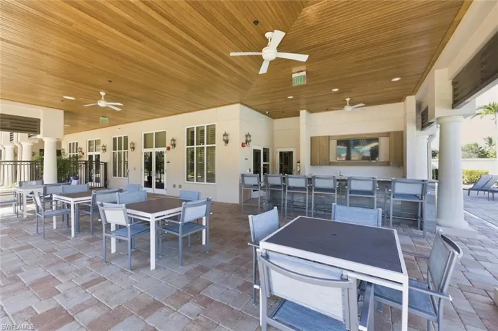 terrace with outdoor dining area and a ceiling fan