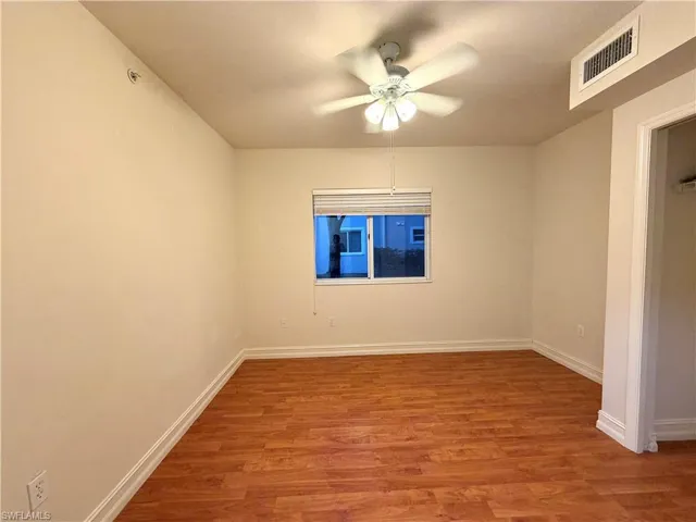 Empty room with light wood-style floors and a ceiling fan