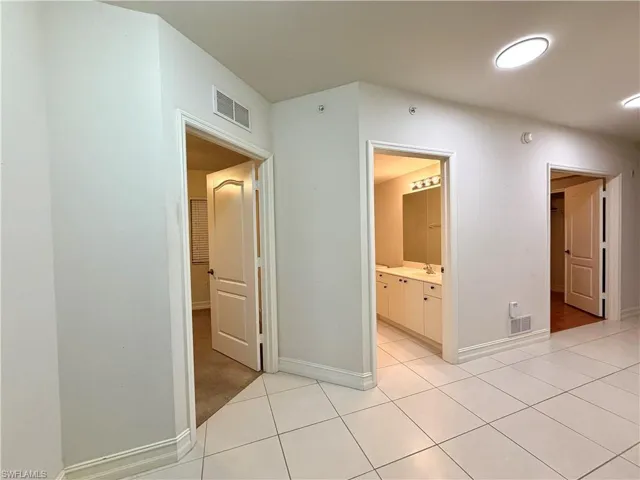 Corridor featuring light tile patterned floors