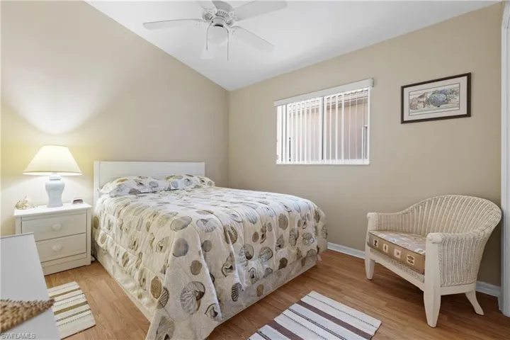 Bedroom featuring light hardwood / wood-style floors, vaulted ceiling, and ceiling fan