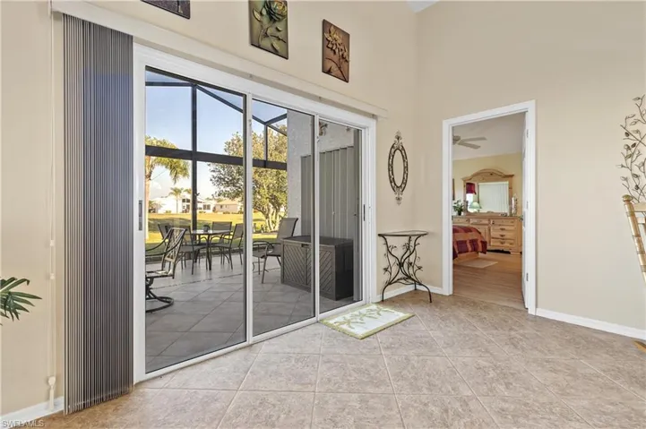 Doorway to outside with tile patterned floors and ceiling fan