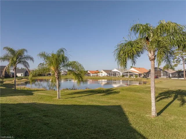 View of property's community featuring a water view and a yard