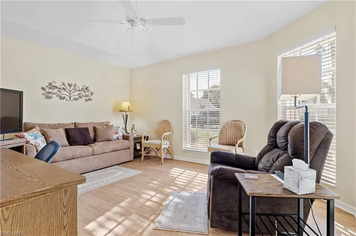 Living room featuring ceiling fan and light hardwood / wood-style floors