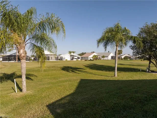 View of home's community with a lawn