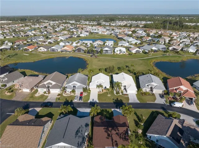 Birds eye view of property with a water view