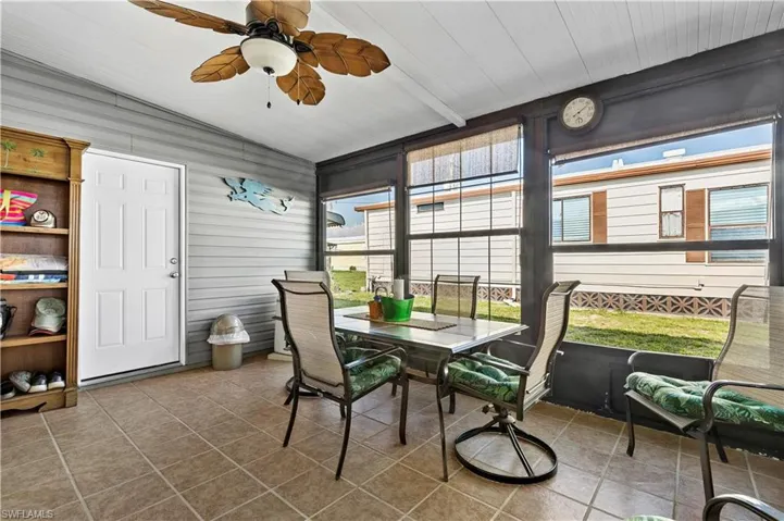 Sunroom / solarium with ceiling fan and vaulted ceiling